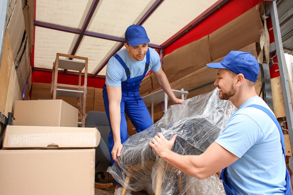 Loaders taking furniture from trucks