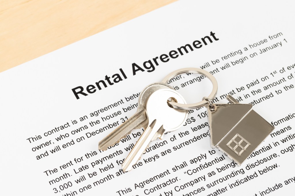 Model lease agreement document with keys on it, showing negotiation for lower rent