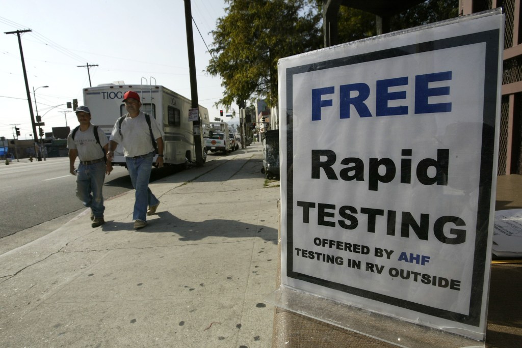 A mobile home converted into a mobile HIV testing laboratory by the AIDS Healthcare Foundation, parked on a busy street in Los Angeles