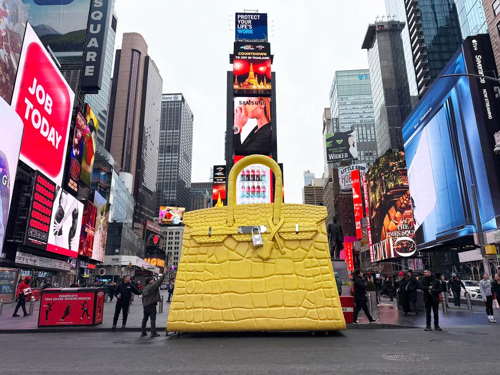 The giant Birkin bag weighs 1,000 pounds. stops traffic en route to expo - police escort required for 19 ft. Tribute to Hermes