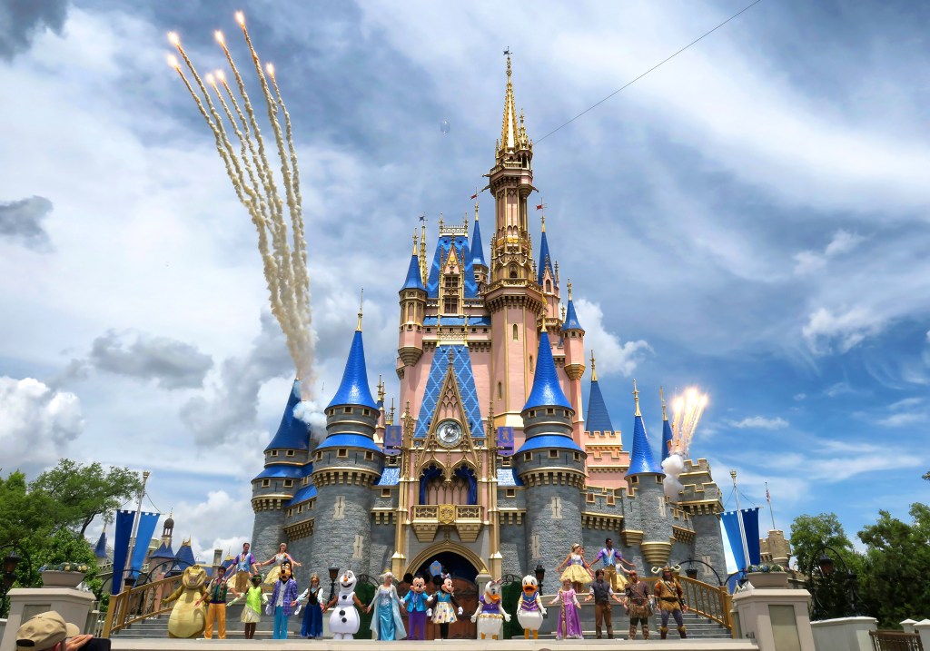 Firecrafts of the day on Cinderella's castle during Mickey's magical friendship performance on Disney World, Bay Lake, Florida, with spectators watching.