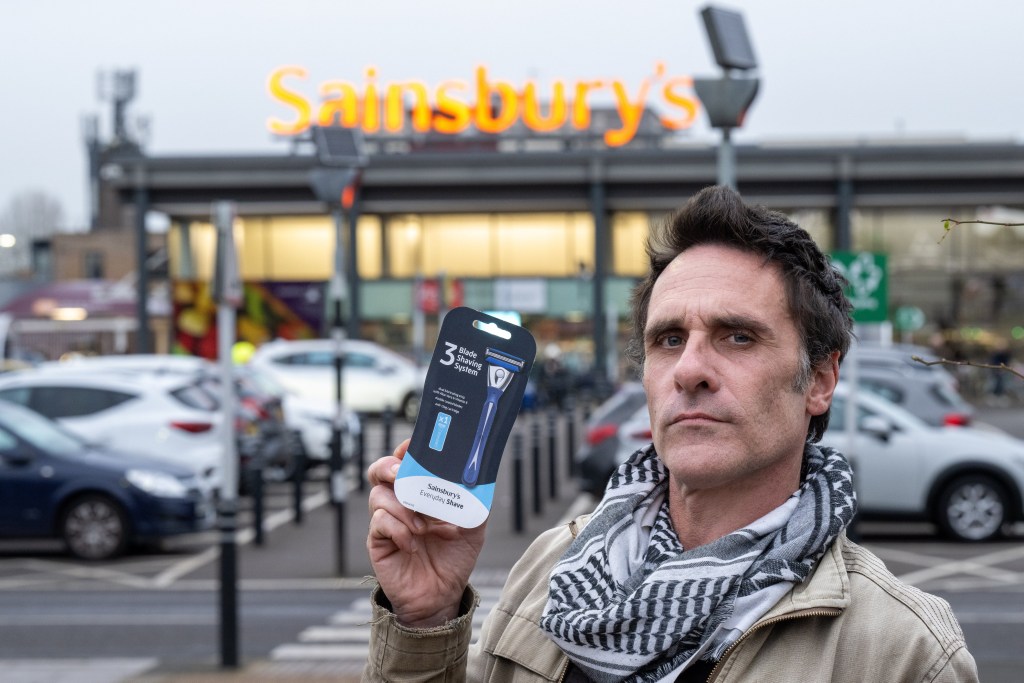 Nick Silverthorn holding a model of the razor he cut himself with after winning £5,000 compensation from a razor company