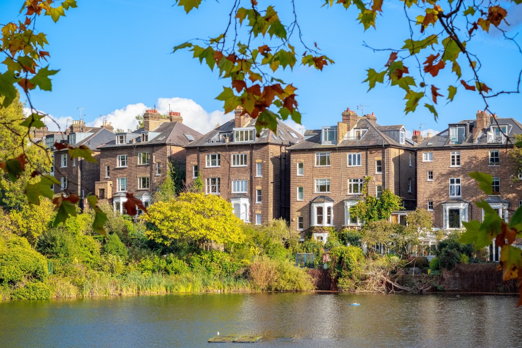 Water apartment in Hampstead Heath, London, reflected in a nearby pond