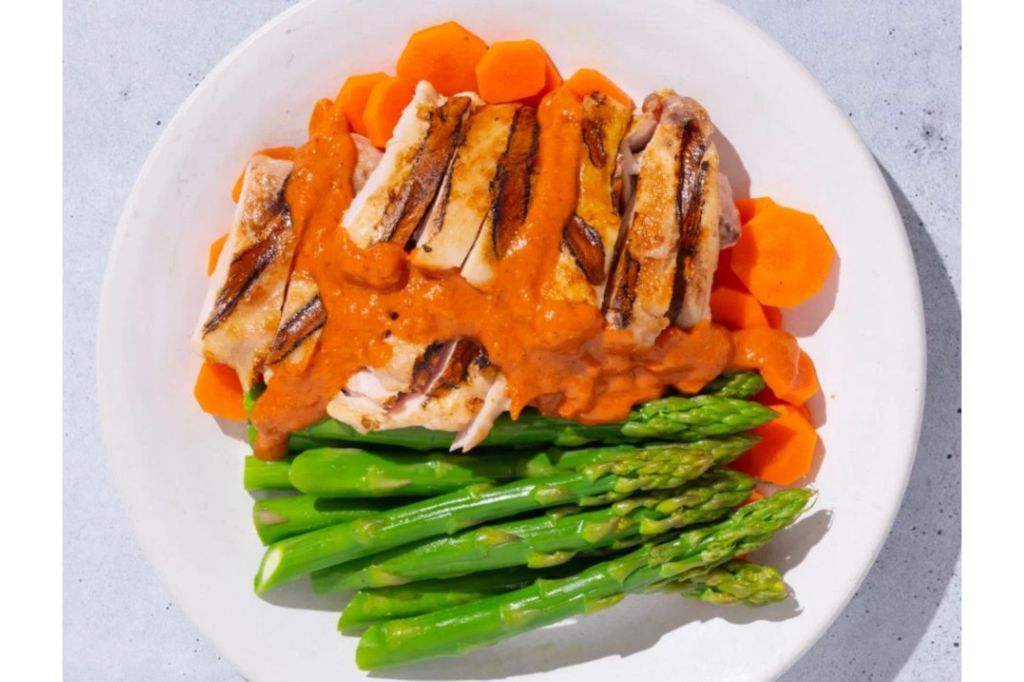 A chicken and vegetable dish with sauce.