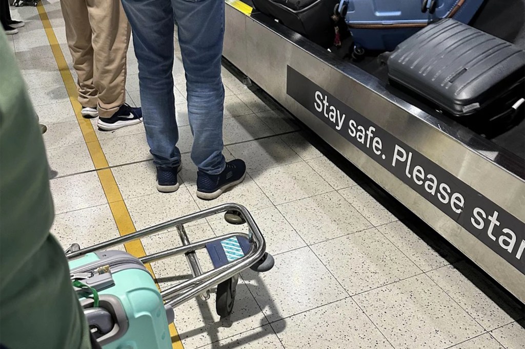 Passengers accumulating in the carousel claim of luggage, ignoring yellow line instructions at Melbourne airport, causing disappointment