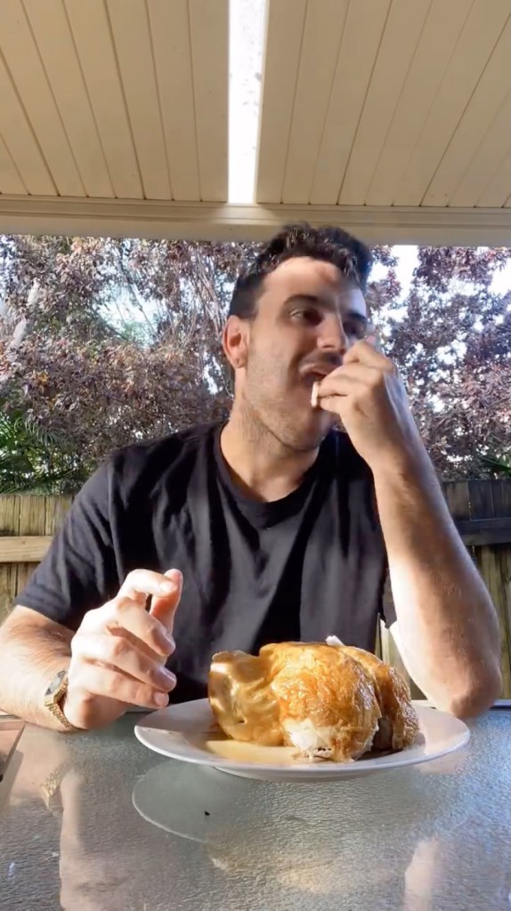 James Ellis, a mural painter, eating a roasted chicken as part of his daily routine