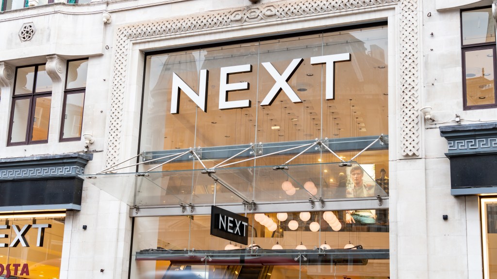 The other logo and the facade of the store in London with a mannequin in leggings posing with one leg straight and the other bent