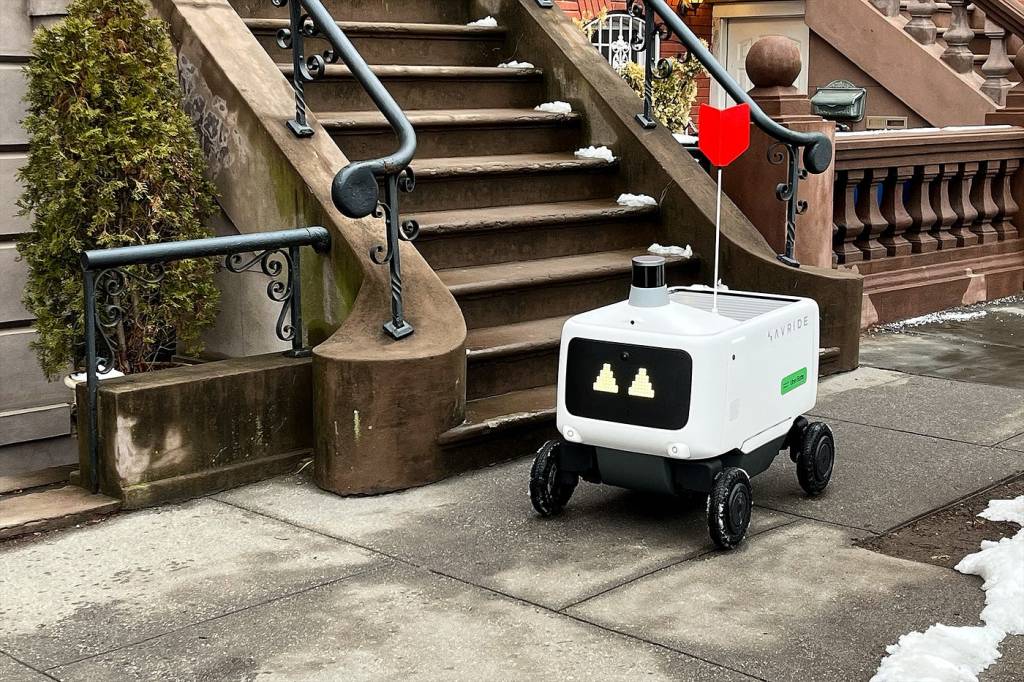 An autonomous Avride robot on wheels giving Uber Eats order in Jersey City, New Jersey.