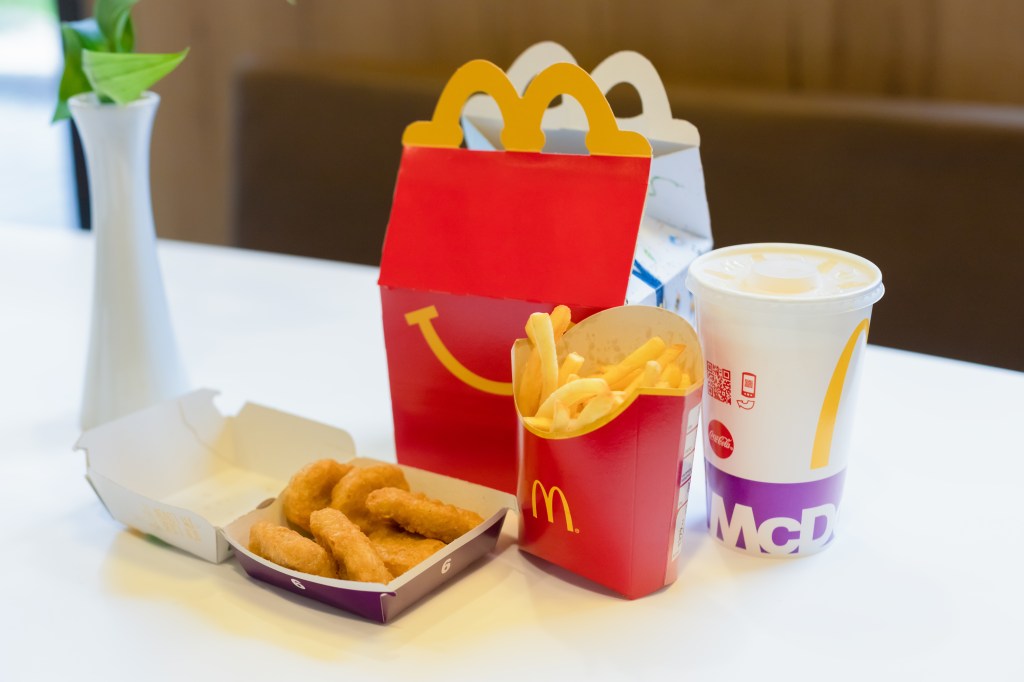 Happy food menu at McDonald's restaurant in Salzburg, Austria presenting Cheeseburger Kids, Chicken McNuggets and Drink