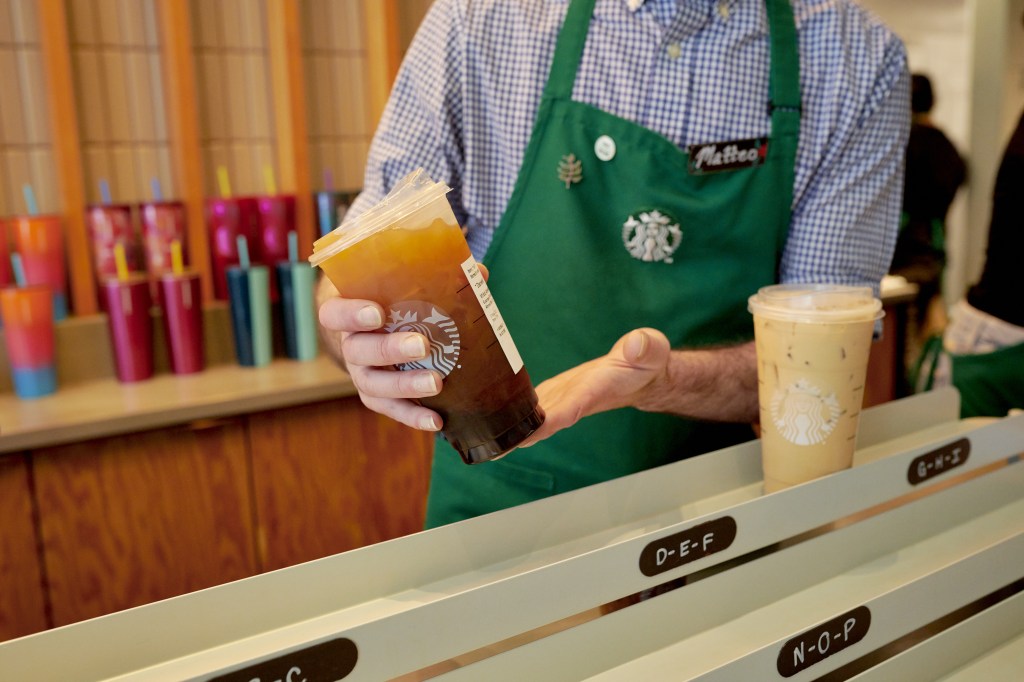 Barista by placing an icy coffee in the mobile pickup area in a Starbucks location in New York