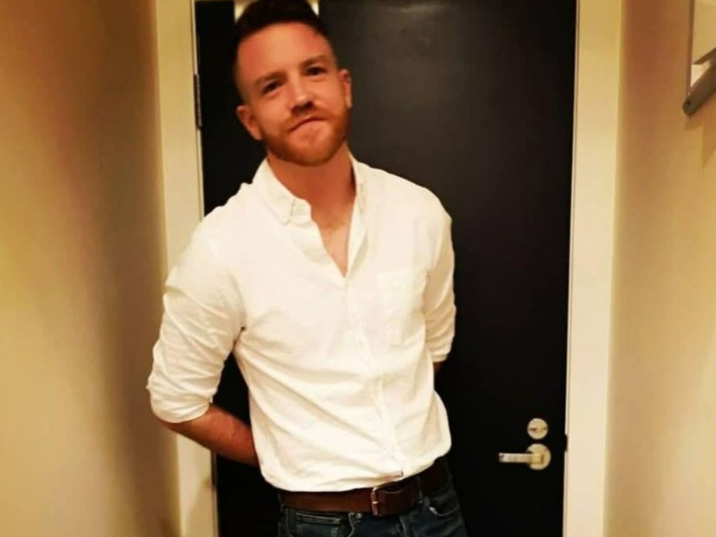 A man standing in front of a door, who has been identified as Jake, known to have a "Penis" But leading a healthy sex life with his girlfriend Penny Talbot.