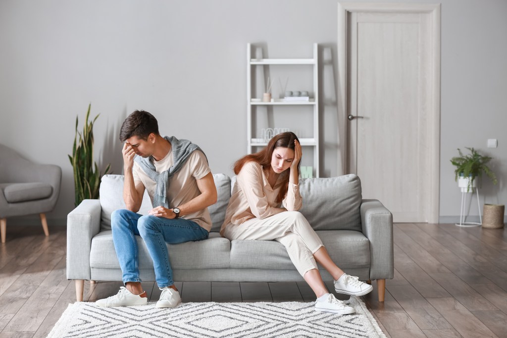 The new updated couple, restoring Helen Reddy, sitting on a sofa at home after a quarrel