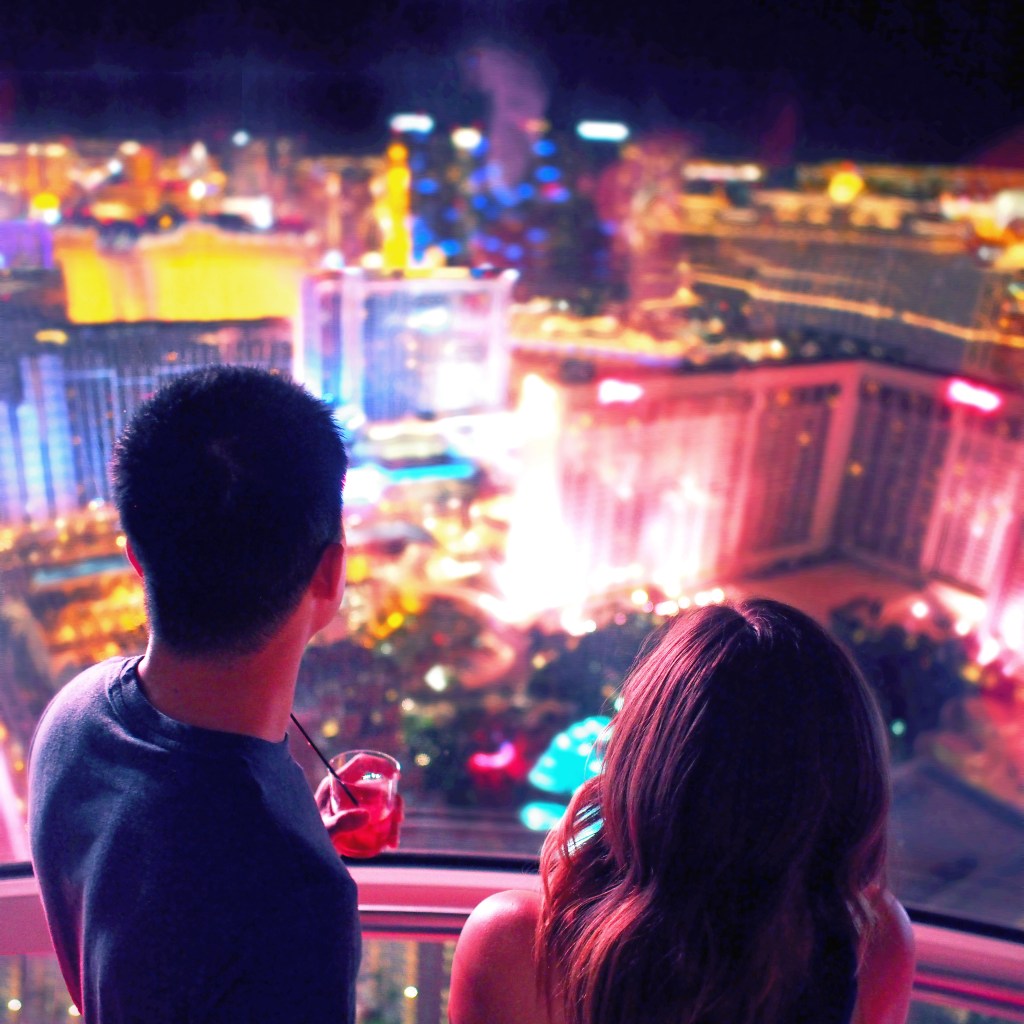 A man and a young woman overlooking the city of Las Vegas