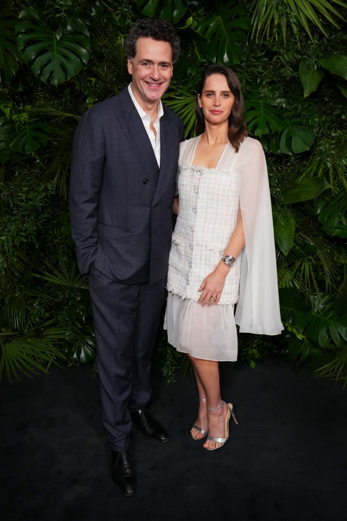 Charles Guard, Left and Felicity Jones arrive at the 16th annual Chanel prize dinner on Saturday, March 1, 2025, at Beverly Hills Hotel in Beverly Hills