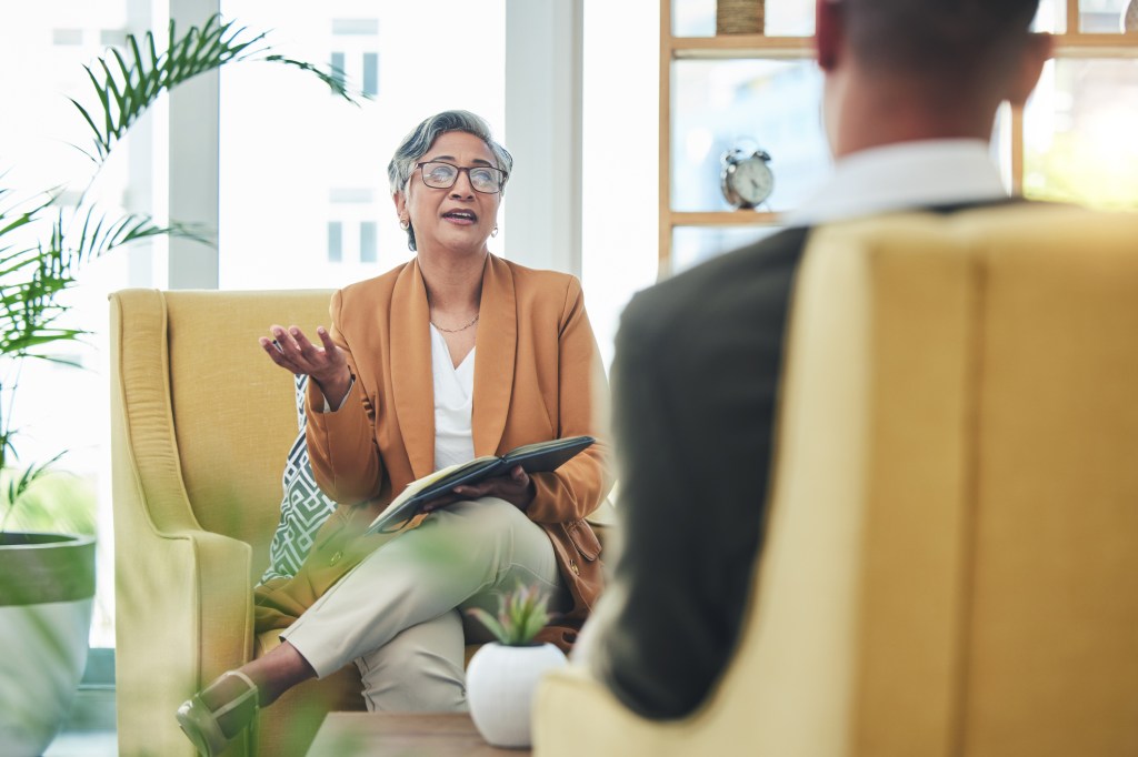 Addressing ORS usually involves a combination of psychotherapy and medication. Here, a female therapist talks to a male patient.