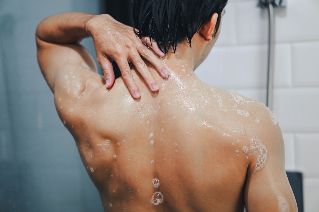 The narrow blow of a person who shower with back 