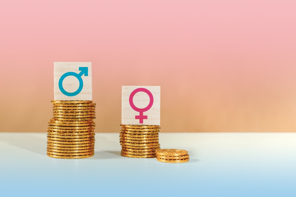 Male and female symbols in gold coins accumulated representing the concept of gender equality of gender salary