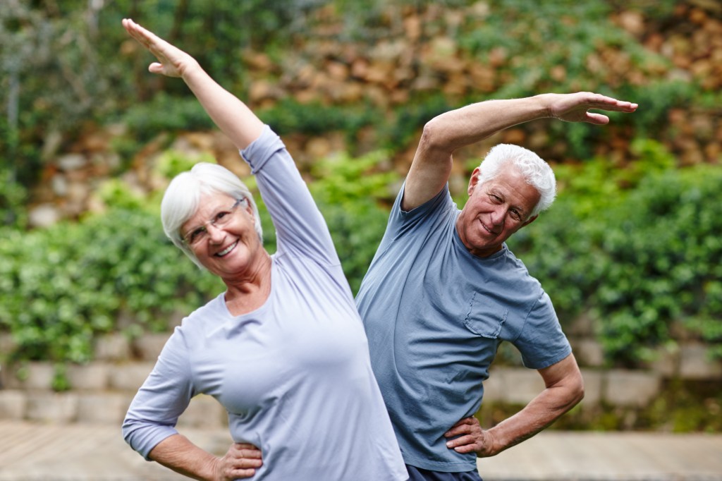 Happy old couple exercising