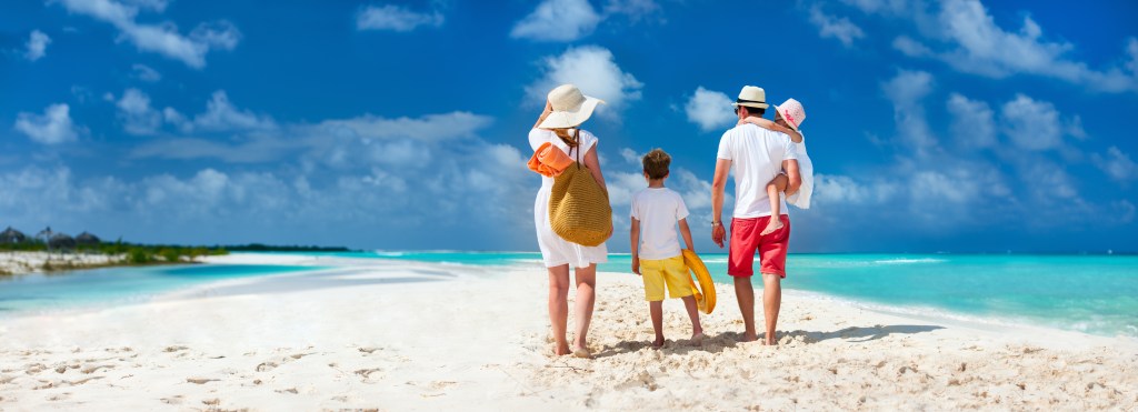 Panoramic view of a happy family with children on a tropical rest on the beach at the Beach Alila Marea Beach Resort